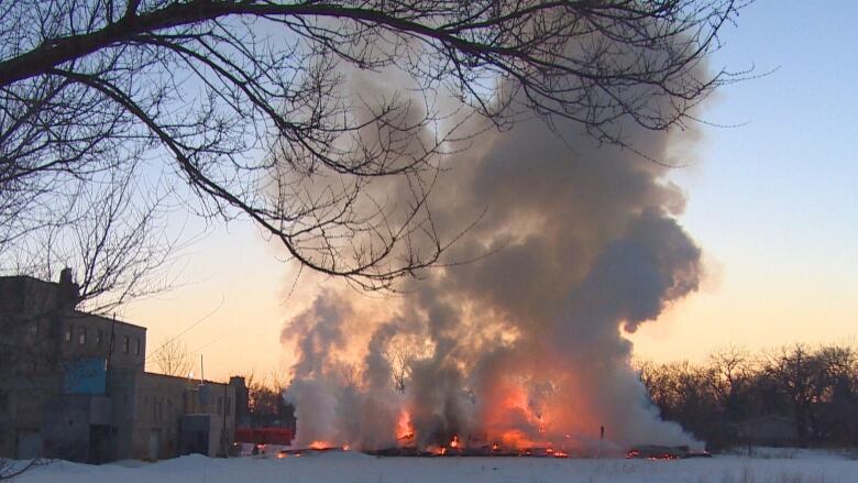 Plumes of white smoke are seen rising from large fire pictured outside.