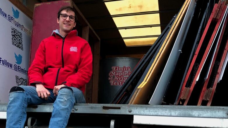 man smiling, truck full of stuff