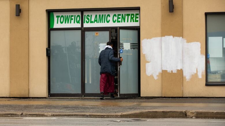 Exterior shot of Towfiq Islamic Centre building with covered up graffiti.