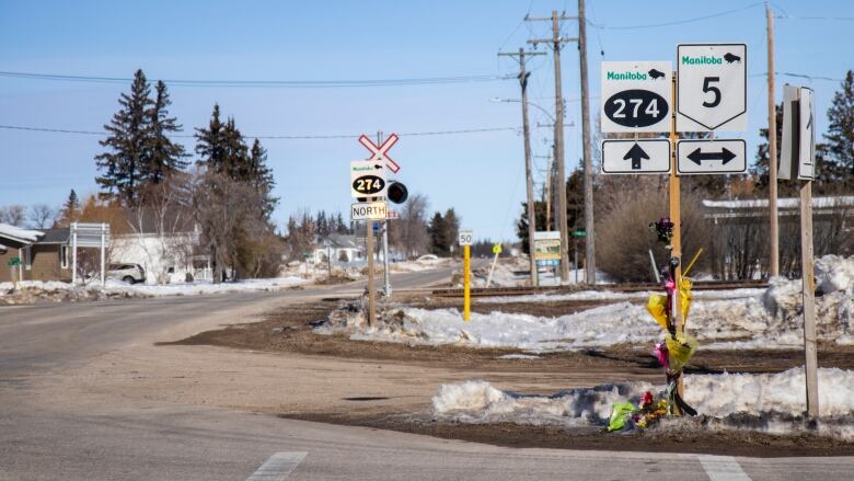 A makeshift roadside memorial at a highway intersection.