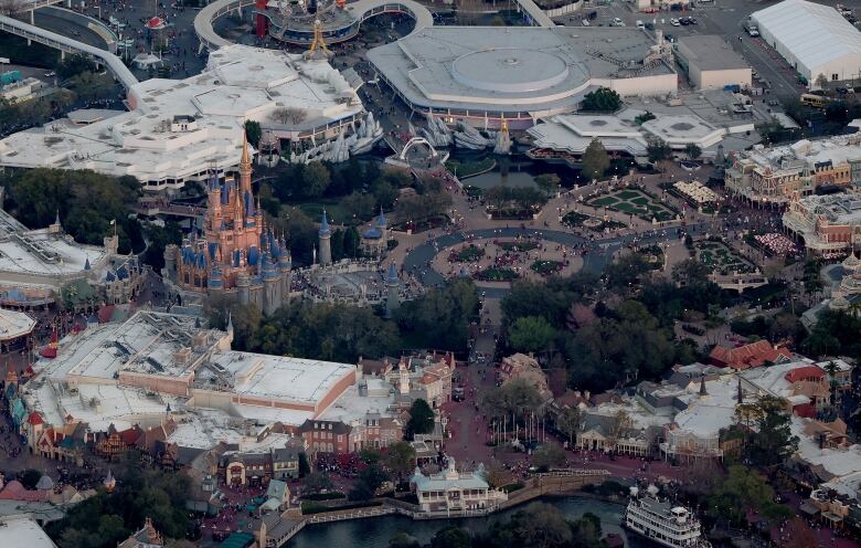 An aerial view of a theme park with a large castle in the centre.