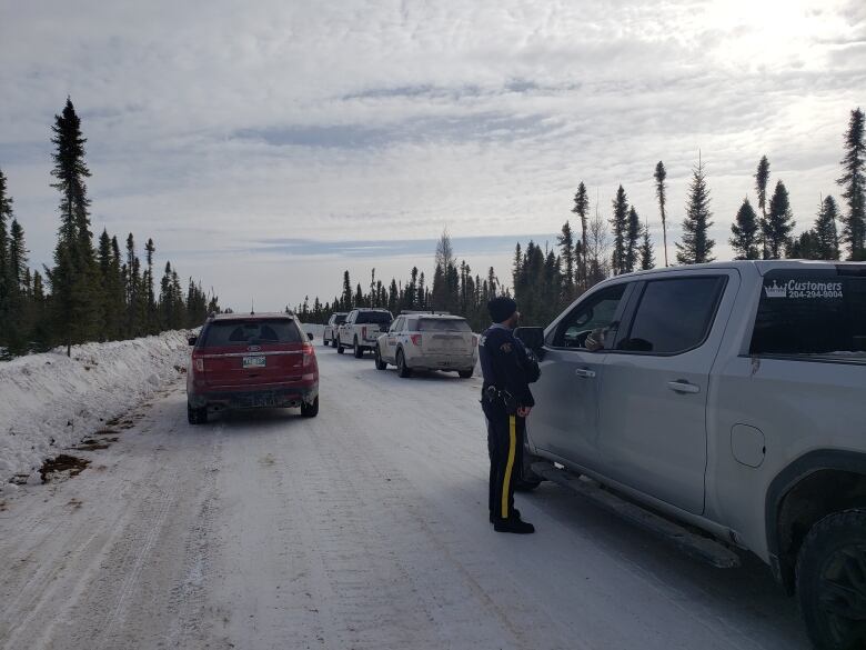 RCMP check vehicles at a winter road checkstop in northern Manitoba in March 2023.