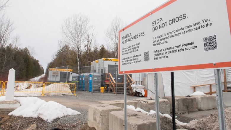 A sign advising people that entrance to Canada via Roxham road is illegal is shown on the Canada/US border in Hemmingford, Que., Saturday, March 25, 2023. 