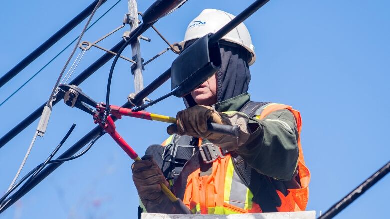 A Hydro worker works on a power line following an ice storm in Montreal.