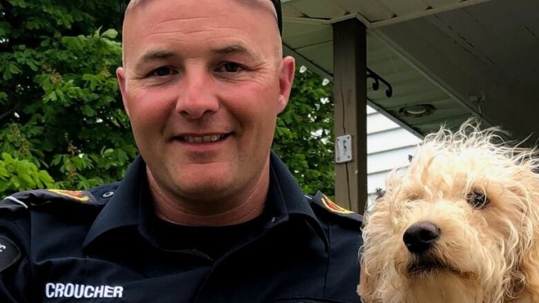 a man holding a dog