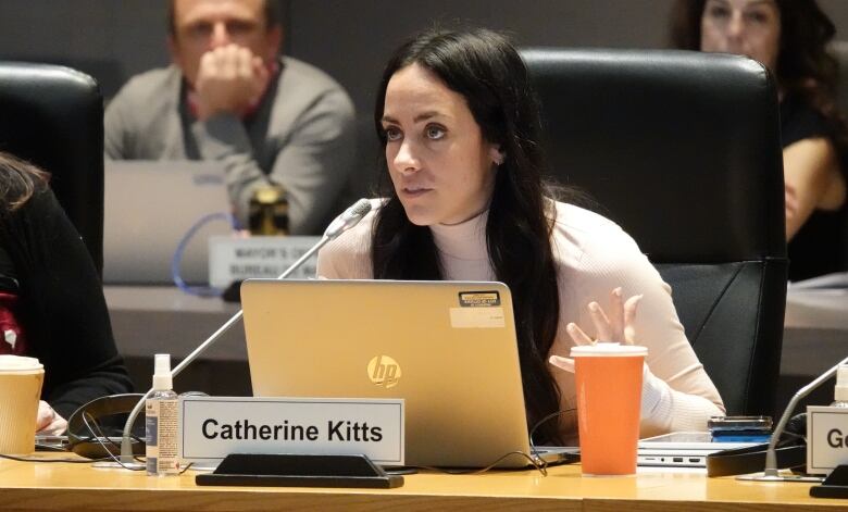 A city councillor speaks during a meeting.