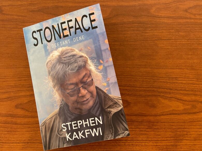 A book titled 'Stoneface' by Stephen Kakfwi is seen on a table.