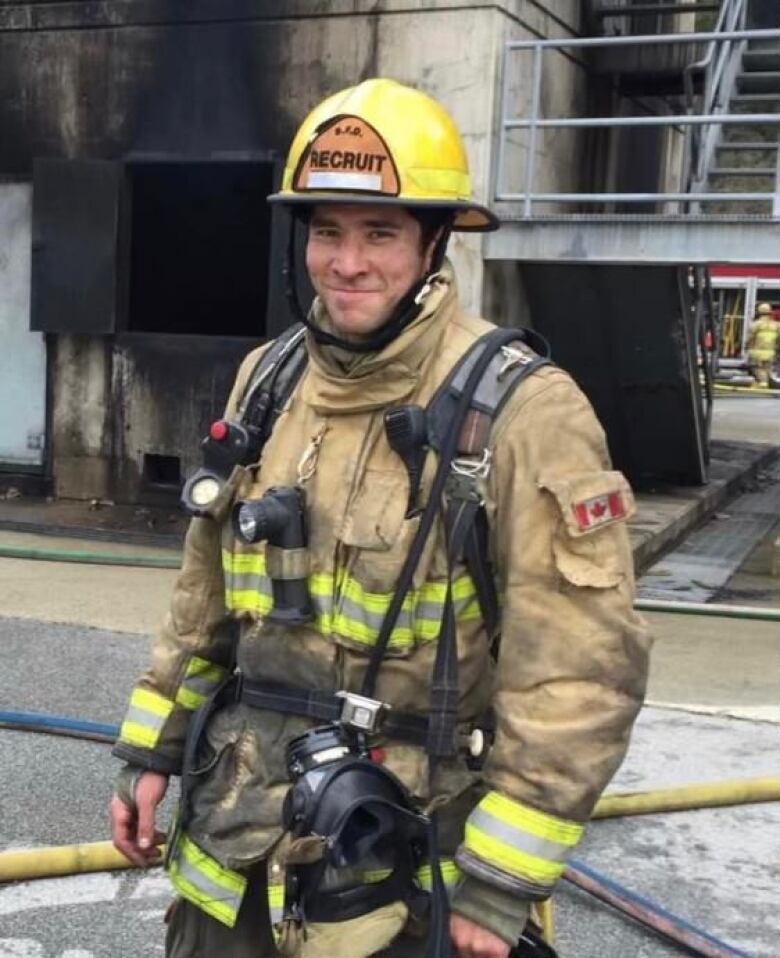 A man in a firefighter's uniform is pictured smiling.