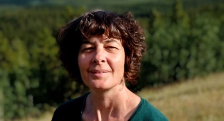 A woman standing outside in a field 