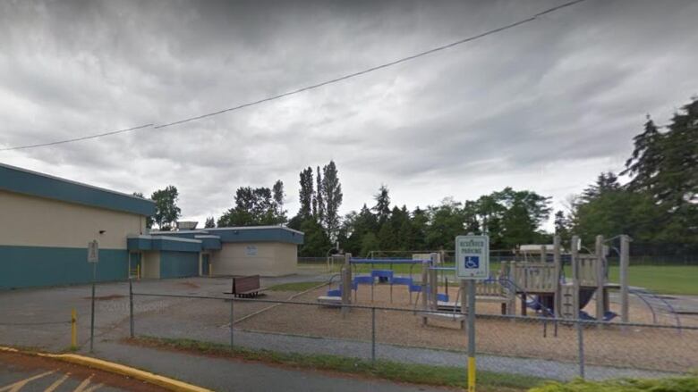 A view of the side of an elementary school and playground.