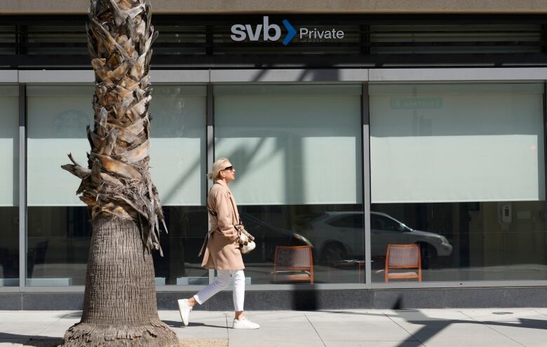 A pedestrian walks past a closed branch of the Silicon Valley Bank in Pasadena, Calif.