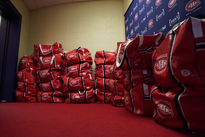 Sports bags piled high.