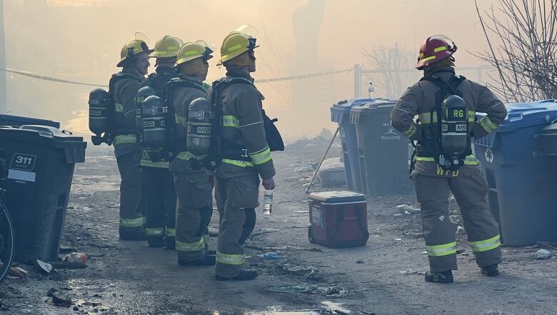 Five crew members look on amidst hazy conditions.