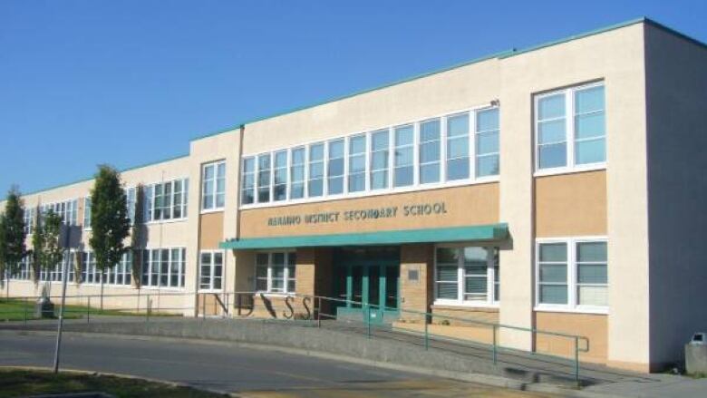 A school building with the words 'Nanaimo District Secondary School'.