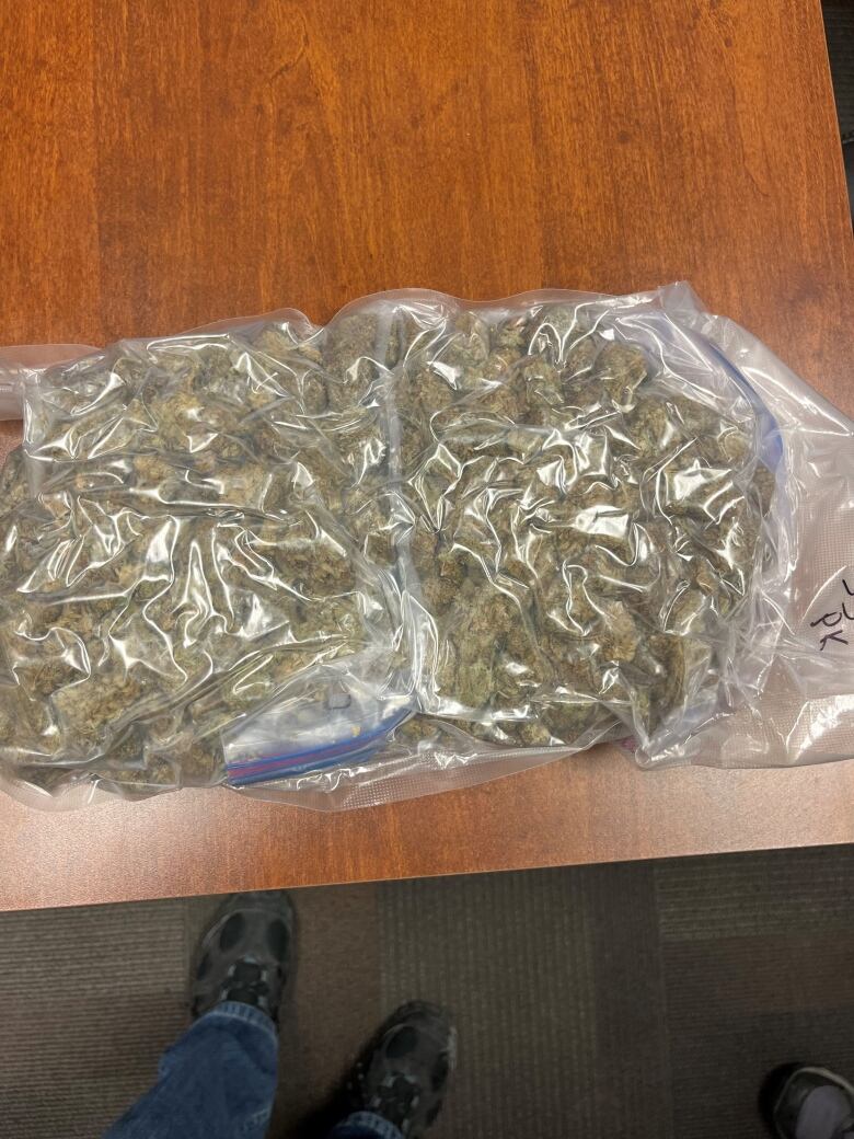 A vacuum-packed bag of illegal cannabis is shown on a table.