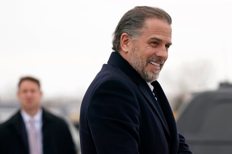 A bearded man is shown wearing a thick coat in an outdoor photo.