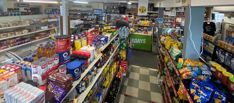 A wide shot of the interior of a convenience store.