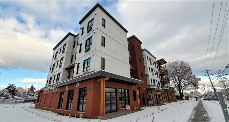 A two-storey building with snow around on the streets.