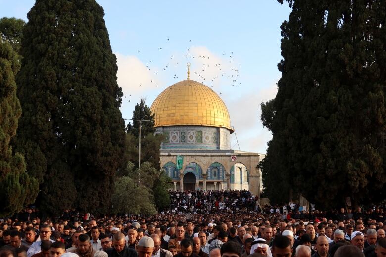 People pray on the street in front of a mosque in Jerusalem's Old City.