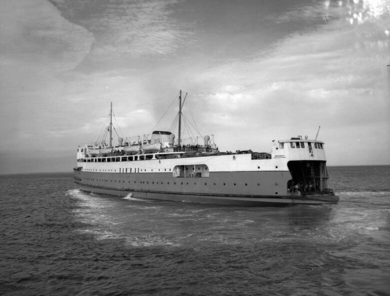 black and white photo of ferry on the water