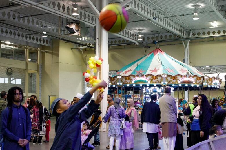 A boy shoots a basketball during a Eid al-Fitr festival in Toronto.