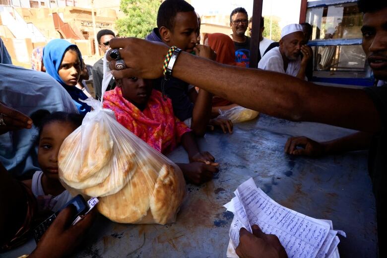 People gather to receive bread.