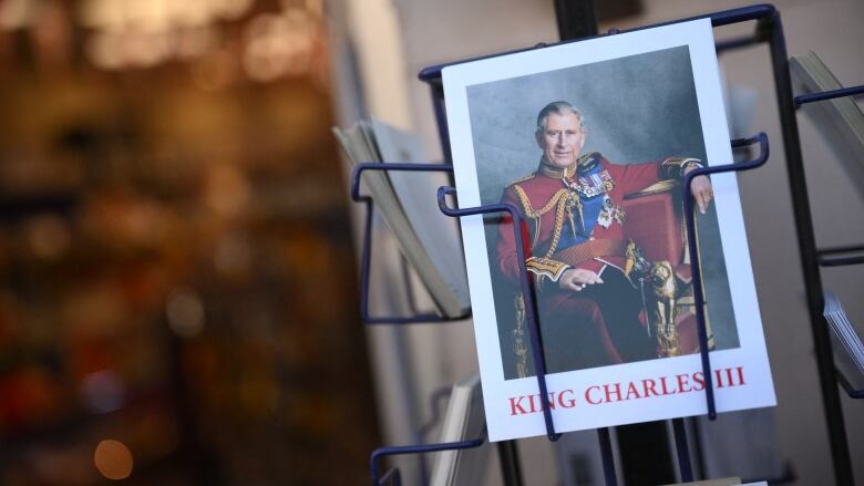 A souvenir postcard with an image of King Charles III on it.