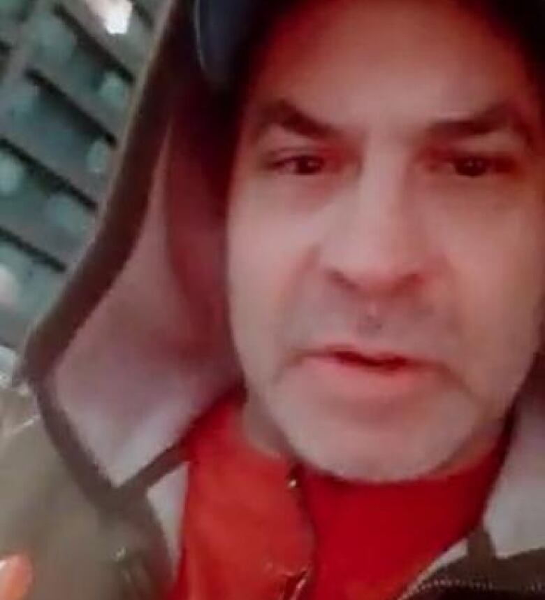 Barber, in screengrab from a Tik Tok video posted Feb. 9, 2022, telling supporters to honk their horns if they see police coming to make arrests.