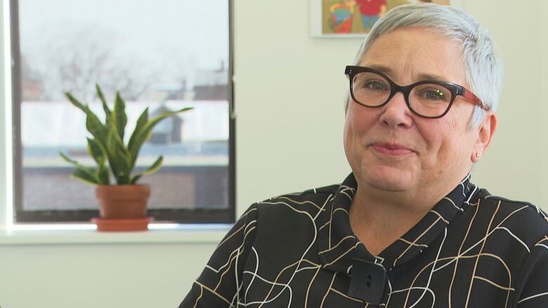 Sandy Hermiston sitting at desk.