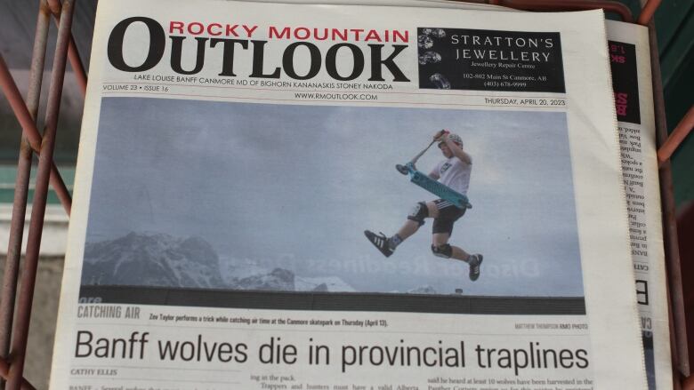 A recent edition of the Rocky Mountain Outlook, a newspaper that covers the Bow Valley, is pictured on a newsstand in Canmore. 