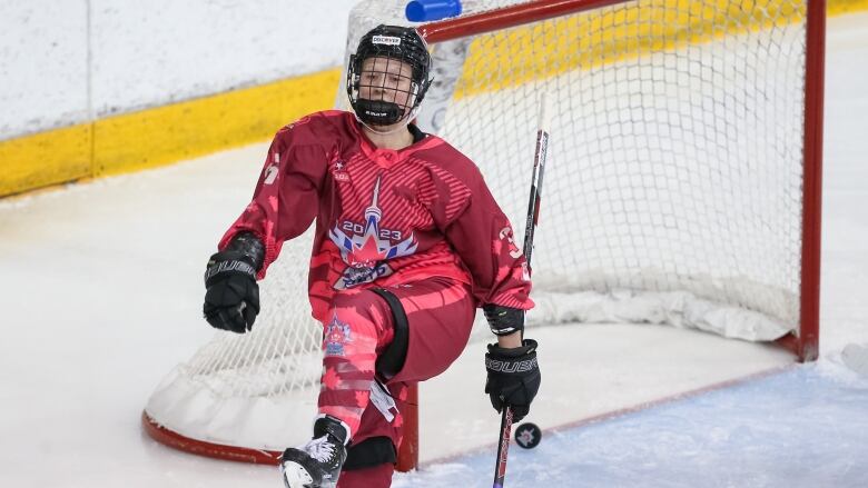 A hockey player celebrates a goal.