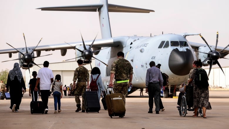 In this handout image provided by the UK Ministry of Defence, on Thursday, April 27, 2023, British Nationals board an RAF aircraft for evacuation of civilians to Larnaca International Airport in Cyprus, at Wadi Seidna military airport, 22 kilometres (14 mi) north of Khartoum, Sudan.