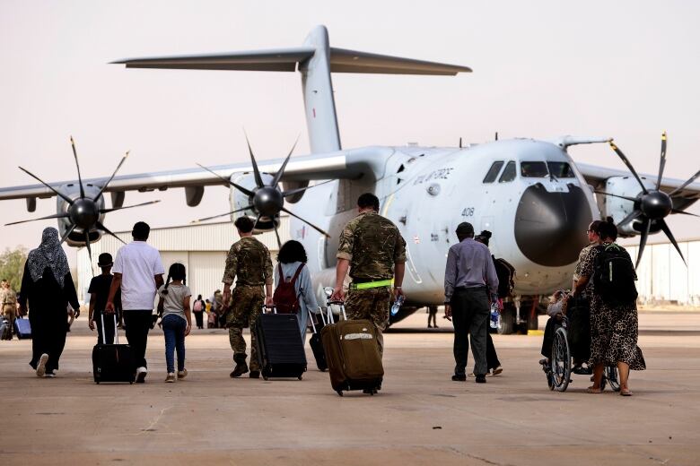 In this handout image provided by the UK Ministry of Defence, on Thursday, April 27, 2023, British Nationals board an RAF aircraft for evacuation of civilians to Larnaca International Airport in Cyprus, at Wadi Seidna military airport, 22 kilometres (14 mi) north of Khartoum, Sudan.