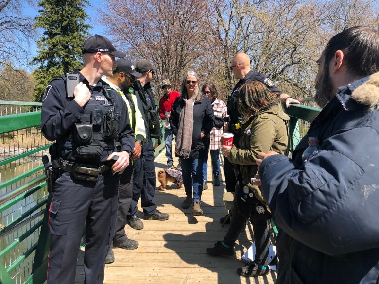 woman walks past security on bridge