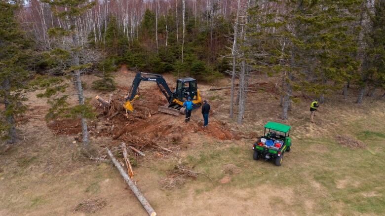 Drone view of machinery working on downed trees 