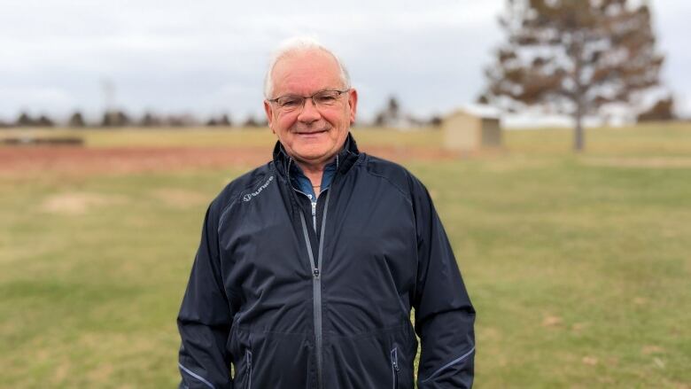 A man standing on a golf course 