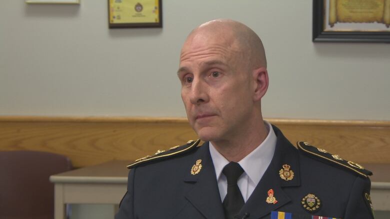 Man in police uniform sitting for interview.