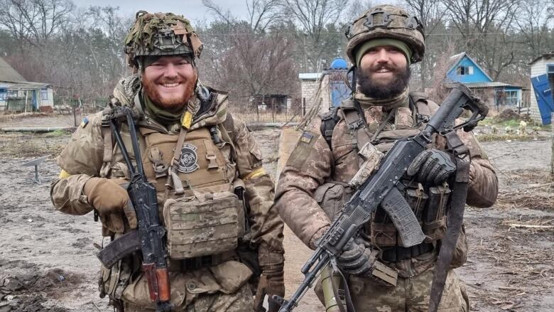 Two people are pictured in military uniforms