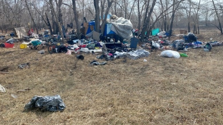 Items scattered around a tent on a patch of grass.