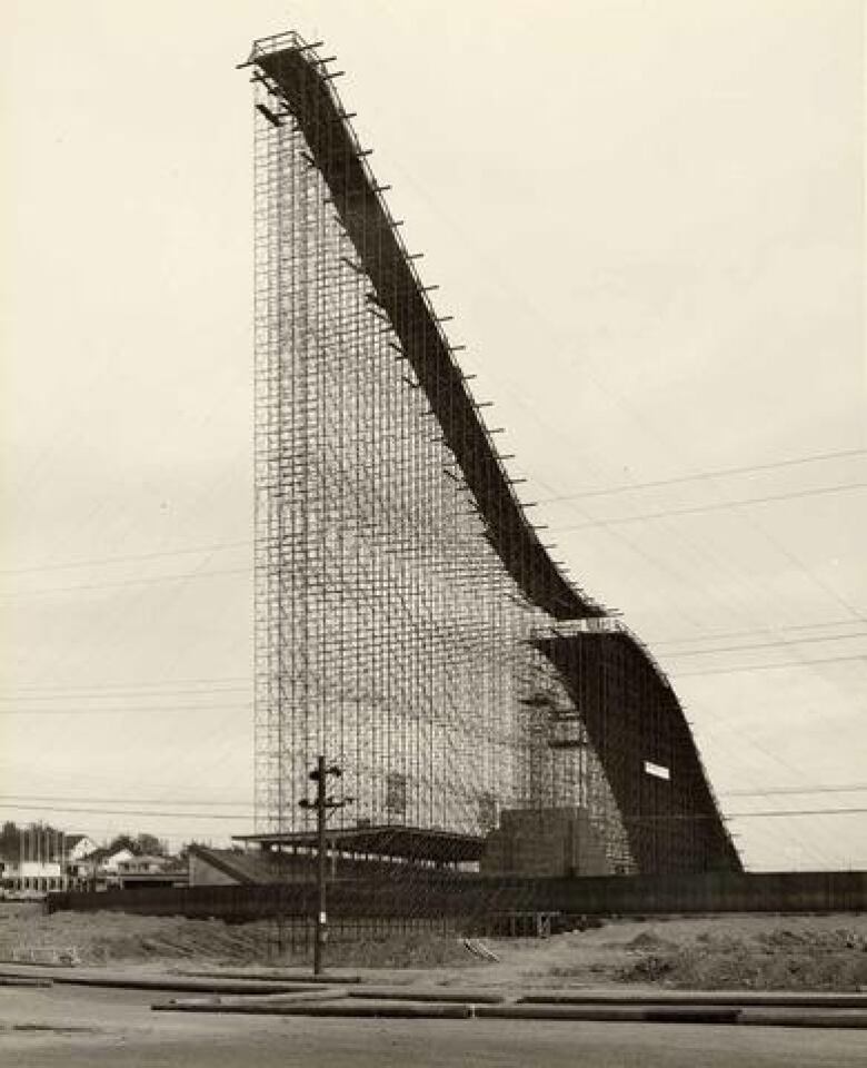 A black-and-white image of an artificial ski hill being constructed.