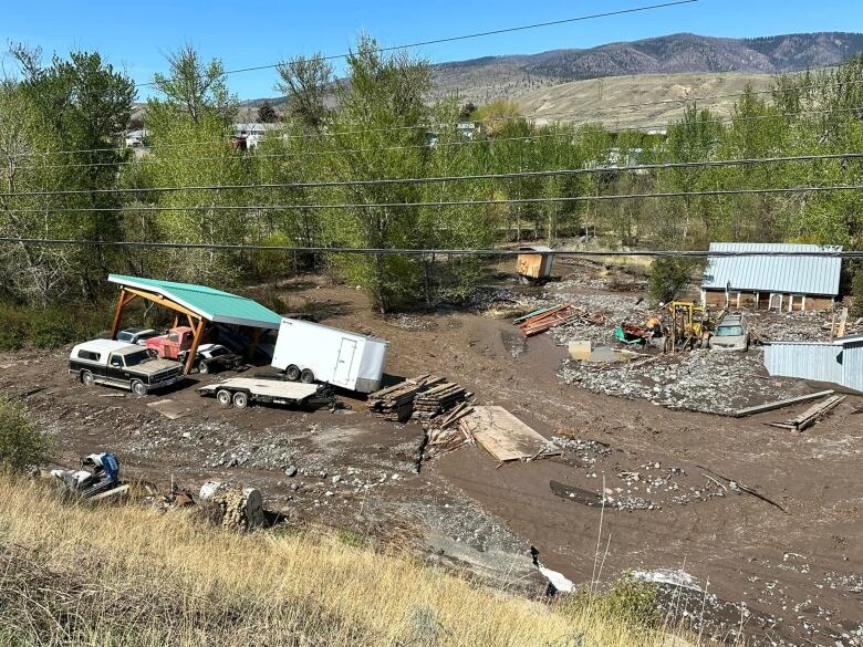 Structures and cars among mud 