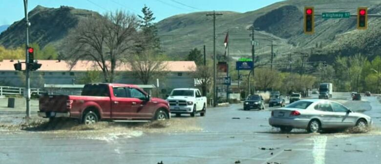 Cars drive through water on the highway