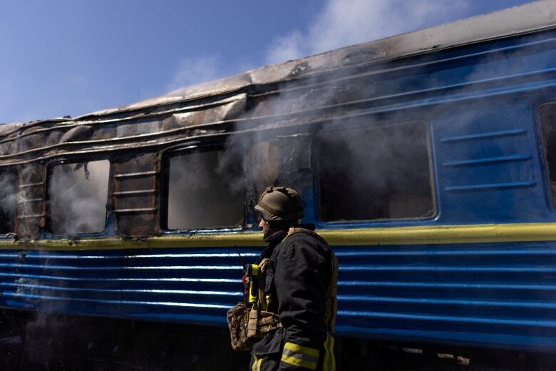 A firefighter at the site of a train station hit by a Russian military strike in Kherson, Ukraine.