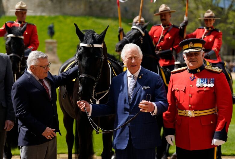 King Charles is pictured with a new horse, Noble.