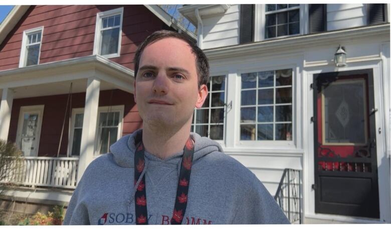 A young man faces a camera.