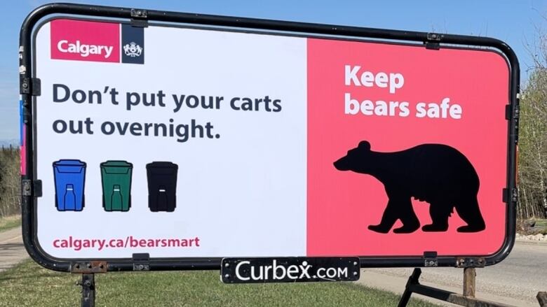 A new sign asking residents not to leave garbage carts out overnight stands alongside the road in Discovery Ridge.