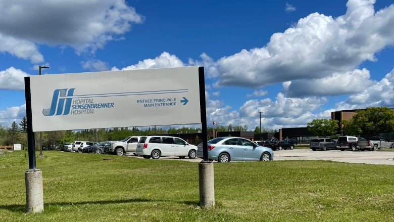 The hospital sign with a parking lot in the background