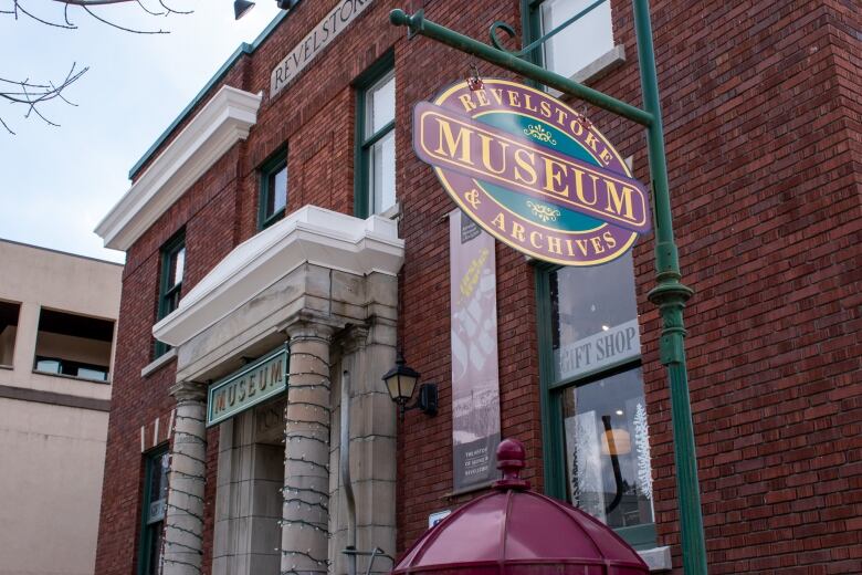 A red brick building with a columned entrance and a sign reading 'Revelstoke Museum and Archives.'