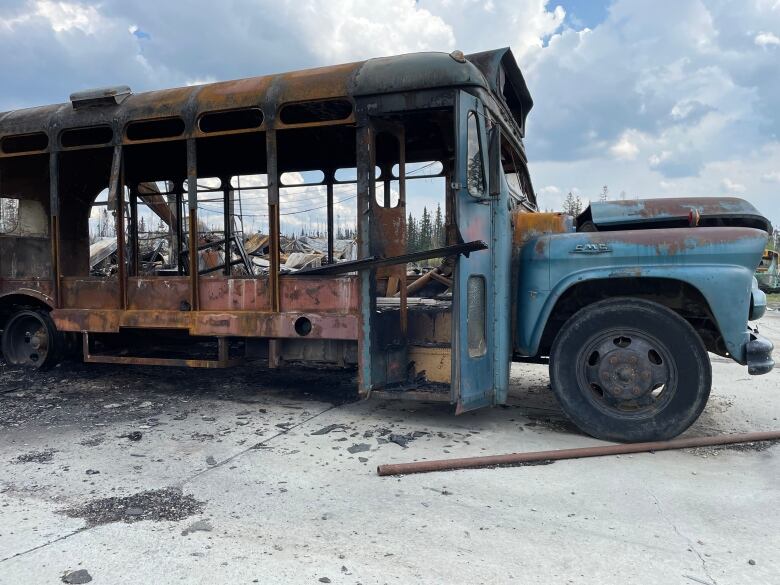 A burned school bus that lacks windows.