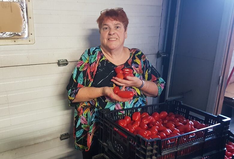 woman holding tomatoes